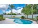 Backyard pool with tropical landscape and clear blue sky views at 912 Pickfair Ter, Lake Mary, FL 32746