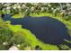 Aerial view of the neighborhood, a lake, mature trees, landscaping, and other residential properties at 9551 Lake Douglas Pl, Orlando, FL 32817