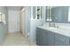 Hall bathroom featuring tiled floors, marble counters, and a shower with tub at 9551 Lake Douglas Pl, Orlando, FL 32817