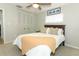 Comfortable bedroom with a large window and closet, featuring neutral décor and soft lighting for a tranquil space at 9551 Lake Douglas Pl, Orlando, FL 32817