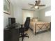 Bedroom featuring a modern ceiling fan, neutral walls, and stylish black metal bed frame and a workstation at 9551 Lake Douglas Pl, Orlando, FL 32817