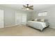 Bedroom with neutral walls, carpet, ceiling fan and natural light from windows and sliding glass door at 9551 Lake Douglas Pl, Orlando, FL 32817