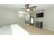 Spacious bedroom with fan, carpet, dresser and TV, featuring a neutral color palette at 9551 Lake Douglas Pl, Orlando, FL 32817