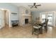 Cozy dining area with a brick fireplace, stylish furnishings, and a welcoming ambiance for memorable meals at 9551 Lake Douglas Pl, Orlando, FL 32817