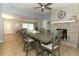 Dining area with a gray table, chairs, and a view into the living room, creating a seamless flow throughout the home at 9551 Lake Douglas Pl, Orlando, FL 32817