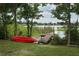 Picturesque lake view with a wooden dock and a red kayak, creating a tranquil waterside setting at 9551 Lake Douglas Pl, Orlando, FL 32817