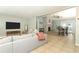 Spacious living room with a gray sofa, stone fireplace, and dining area, perfect for Gathering gatherings and relaxation at 9551 Lake Douglas Pl, Orlando, FL 32817
