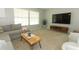 Cozy living area featuring a modern TV setup, neutral-toned furnishings, and a warm, inviting atmosphere at 9551 Lake Douglas Pl, Orlando, FL 32817