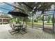 Covered patio with screened enclosure features an outdoor dining set, creating an inviting space for gatherings at 9551 Lake Douglas Pl, Orlando, FL 32817