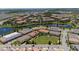 An aerial view showcasing the home in the neighborhood with a beautiful pond and fountain at 10072 Sunnifa Aly, Orlando, FL 32832
