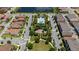 Aerial view features the community's lush landscaping, playground, and sparkling blue community pool at 10072 Sunnifa Aly, Orlando, FL 32832