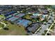 Aerial view featuring basketball and tennis courts with community pool and clubhouse in the distance at 10072 Sunnifa Aly, Orlando, FL 32832