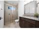 Bathroom featuring a tiled glass shower, granite vanity, tile floors, and updated fixtures at 10072 Sunnifa Aly, Orlando, FL 32832