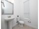 Bathroom with sleek pedestal sink, silver framed mirror, and a toilet at 10072 Sunnifa Aly, Orlando, FL 32832