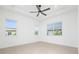 Bright bedroom featuring neutral paint, tile floors, and large windows for ample natural light at 10072 Sunnifa Aly, Orlando, FL 32832