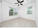 Bright bedroom featuring neutral paint, tile floors, and large windows for ample natural light at 10072 Sunnifa Aly, Orlando, FL 32832