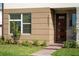 Inviting townhome entrance with a brick walkway, stylish front door, and meticulously landscaped garden at 10072 Sunnifa Aly, Orlando, FL 32832