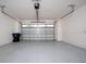 Spacious, two car garage featuring an automatic overhead door and concrete floors at 10072 Sunnifa Aly, Orlando, FL 32832