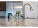 Kitchen sink and faucet and decorative signage with a modern stainless steel refrigerator at 10072 Sunnifa Aly, Orlando, FL 32832