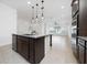 Open-concept kitchen featuring a large island with granite countertops and modern appliances at 10072 Sunnifa Aly, Orlando, FL 32832
