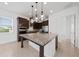 Spacious kitchen featuring a large island with granite countertops and pendant lighting at 10072 Sunnifa Aly, Orlando, FL 32832