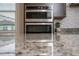 Modern kitchen featuring stainless steel appliances and granite countertops at 10072 Sunnifa Aly, Orlando, FL 32832