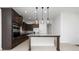 Spacious kitchen with dark wood cabinetry, a large island, and modern pendant lighting at 10072 Sunnifa Aly, Orlando, FL 32832