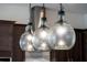 Close-up of modern pendant lights hanging over a kitchen island at 10072 Sunnifa Aly, Orlando, FL 32832