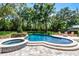 Inviting backyard pool and spa with a stone patio and lush landscaping at 105 Laurel Oak Dr, Longwood, FL 32779