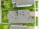 An overhead shot displays the roof of the house, bordered by well-manicured green grass and white fences at 12216 Encore At Ovation Way, Winter Garden, FL 34787