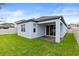 Backyard features lush green grass, a privacy fence, and a covered patio with brick flooring at 12216 Encore At Ovation Way, Winter Garden, FL 34787