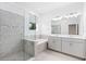 Modern bathroom featuring a glass shower, soaking tub, and double vanity at 12216 Encore At Ovation Way, Winter Garden, FL 34787