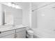 Bright bathroom with tiled shower and bath, white vanity, and decorative lights and mirror at 12216 Encore At Ovation Way, Winter Garden, FL 34787