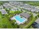 Community pool with a covered seating area and well-kept landscaping offers residents a relaxing and social outdoor space at 12216 Encore At Ovation Way, Winter Garden, FL 34787