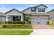 Charming two-story home with brick-paved driveway, manicured landscaping, blue shutters and a two-car garage at 12216 Encore At Ovation Way, Winter Garden, FL 34787