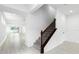 Open-concept hallway with tile floors, a carpeted staircase with dark wood banister and wrought iron spindles at 12216 Encore At Ovation Way, Winter Garden, FL 34787