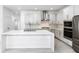 Well-lit kitchen with stainless steel appliances, a quartz island, modern cabinets, and tile flooring at 12216 Encore At Ovation Way, Winter Garden, FL 34787