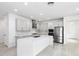 Contemporary kitchen with stainless steel appliances, modern cabinets, a white quartz island, and tile floors at 12216 Encore At Ovation Way, Winter Garden, FL 34787