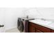 Practical laundry room with modern washer and dryer, utility sink, and wire rack shelf at 12216 Encore At Ovation Way, Winter Garden, FL 34787