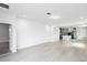 Bright, open-concept living space with light tile flooring and kitchen view at 12216 Encore At Ovation Way, Winter Garden, FL 34787