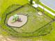 Aerial view of a fenced playground area, featuring a slide and various play structures for outdoor fun at 12216 Encore At Ovation Way, Winter Garden, FL 34787