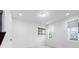 Bright room featuring clean white walls, tile flooring, a window with blinds, and minimalist shelving at 12216 Encore At Ovation Way, Winter Garden, FL 34787