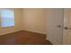 A bedroom with a window and a door to a closet and hardwood floors at 13584 Turtle Marsh Loop # 12, Orlando, FL 32837
