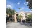 Condo exterior featuring covered parking, mature trees, and a palm tree at 13584 Turtle Marsh Loop # 12, Orlando, FL 32837