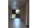 Well-lit hallway leading to a staircase with black metal railings and a glimpse of greenery outside at 13584 Turtle Marsh Loop # 12, Orlando, FL 32837