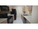 The kitchen has stainless steel appliances, tile backsplash and white tiled floor at 13584 Turtle Marsh Loop # 12, Orlando, FL 32837