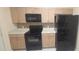 A kitchen with black appliances, and light wood cabinets at 13584 Turtle Marsh Loop # 12, Orlando, FL 32837