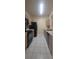 View of the kitchen with black appliances, tiled backsplash and white tiled floor at 13584 Turtle Marsh Loop # 12, Orlando, FL 32837