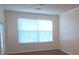 Well-lit living room featuring a big window, blinds, neutral paint, and hardwood floors at 13584 Turtle Marsh Loop # 12, Orlando, FL 32837