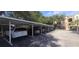 Parking featuring covered parking spaces and mature trees at 13584 Turtle Marsh Loop # 12, Orlando, FL 32837